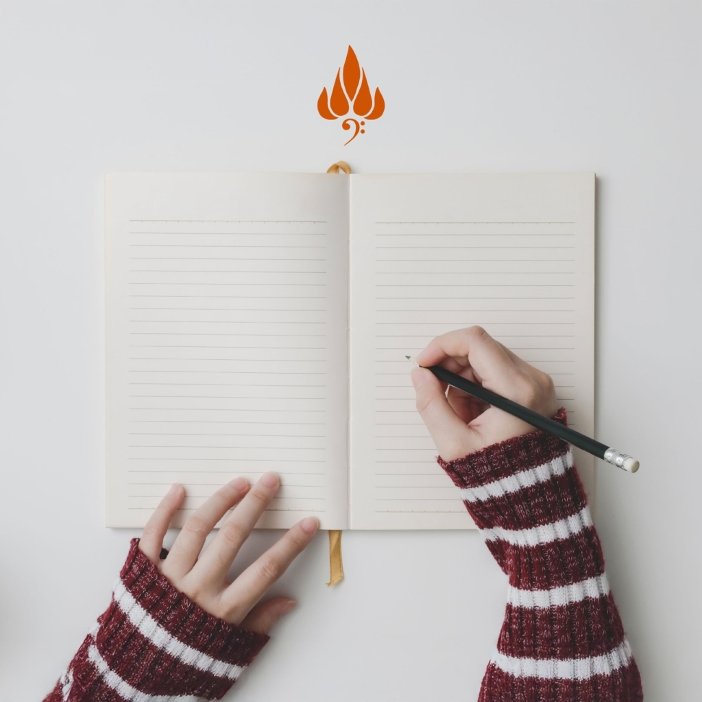Person Writing on Notebook